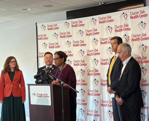 Officials stand at a podium to announce free epi pen distribution